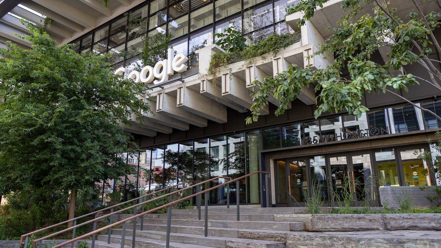 Google sign on the front of the St. John's Terminal office building in New York, with trees and steps in front