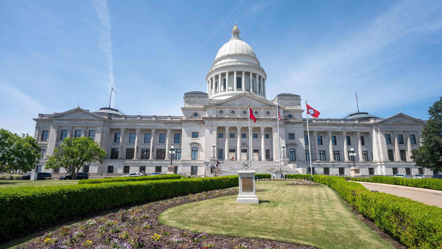 The domed Arkansas State Capitol building in Little Rock under a blue sky