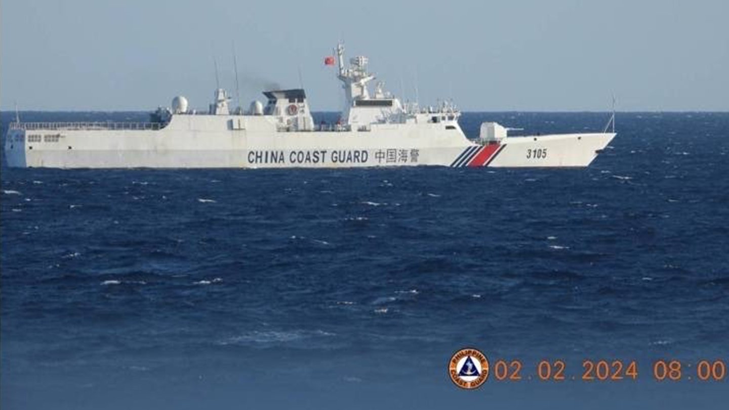 A white China Coast Guard ship with the hull number 3105 sailing on blue open sea