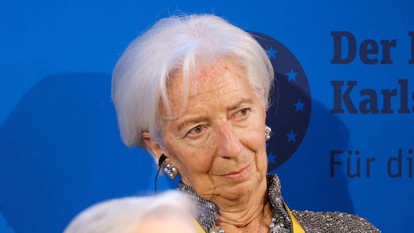 European Central Bank President Christine Lagarde in front of a blue backdrop with the European stars, at the Charlemagne Prize ceremony in Aachen