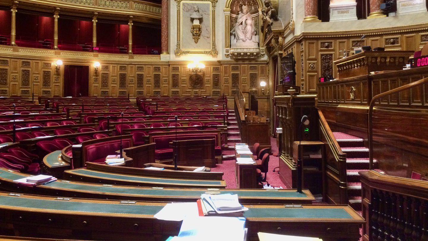 The red-seated semicircular chamber of the French Senate in the Palais du Luxembourg, Paris, seen from the speaker's platform
