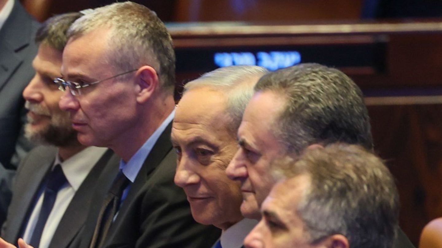 Benjamin Netanyahu, grey-haired and in a dark suit, sits among Israeli ministers in the Knesset chamber