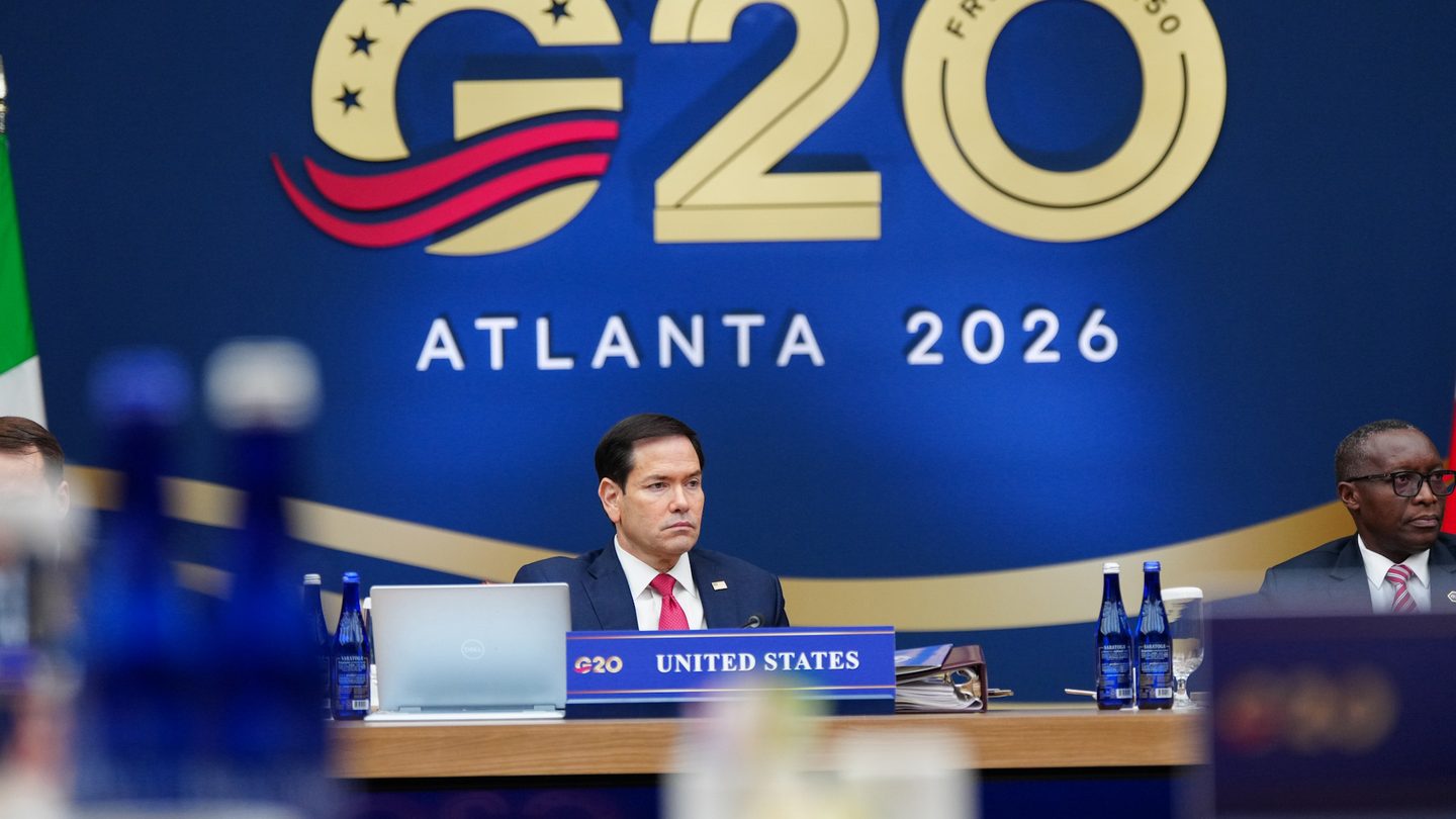 US Secretary of State Marco Rubio seated at the United States place at the G20 foreign ministers' meeting in front of a G20 Atlanta 2026 backdrop