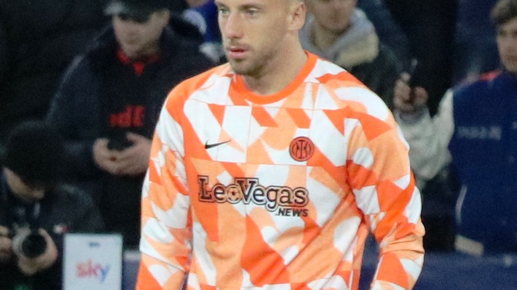Inter player Carlos Augusto, number 30, in an orange warm-up shirt before a Champions League match