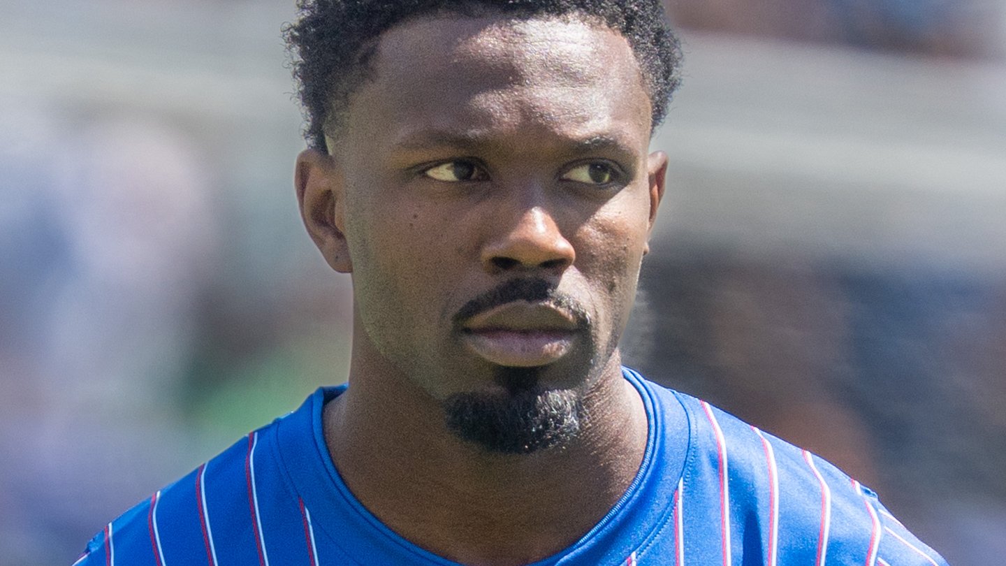 Marcus Thuram in a blue striped France shirt, close-up on the pitch during a match