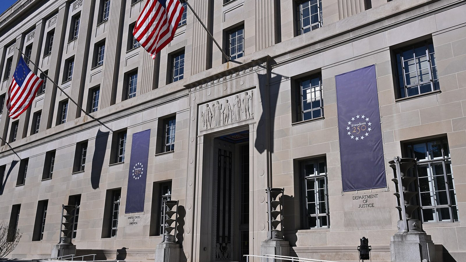 Entrance of the Robert F. Kennedy Department of Justice Building in Washington with banners and US flags