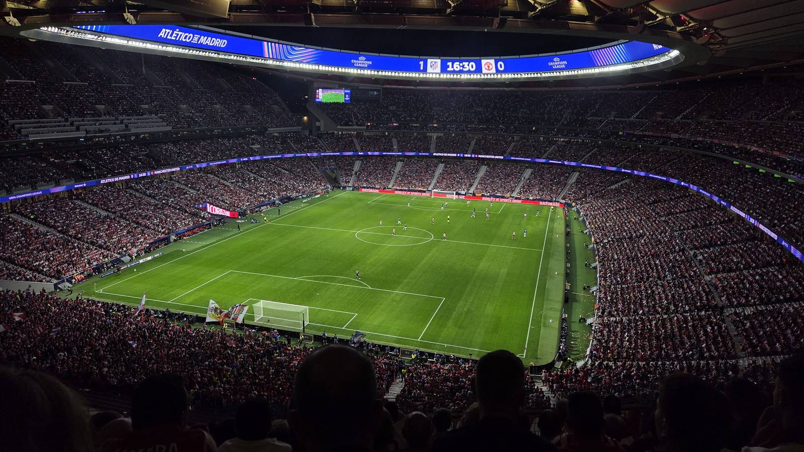 Atlético Madrid's Metropolitano stadium at night during a match, with a full crowd around the floodlit pitch