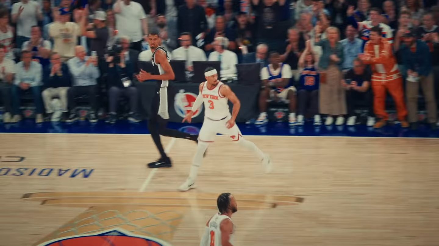 New York Knicks guard Josh Hart, in a white number 3 jersey and headband, runs up the court at Madison Square Garden next to San Antonio's Victor Wembanyama