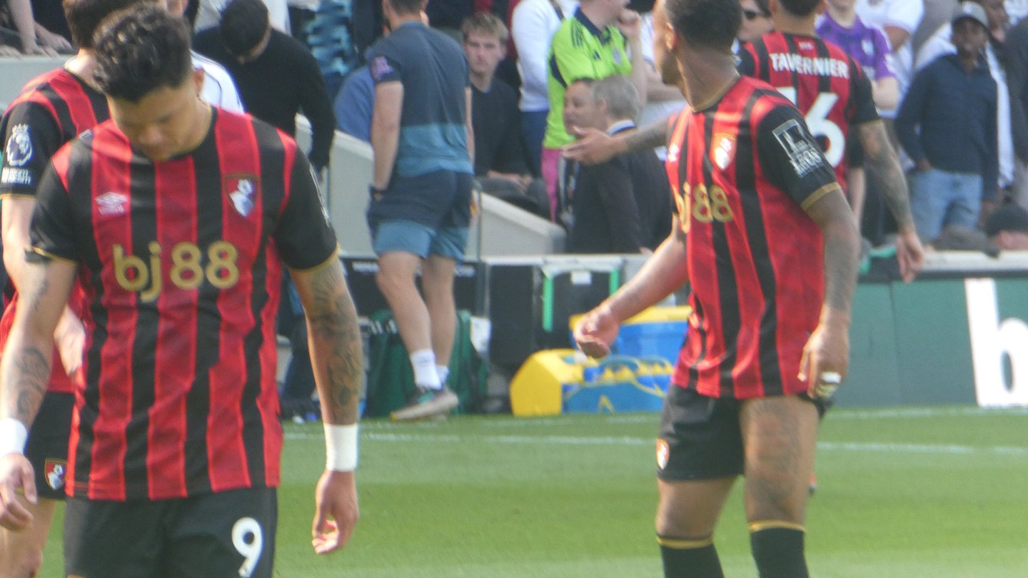 Bournemouth players, including Evanilson in the number 9 shirt, in red and black striped kits on the pitch during a match