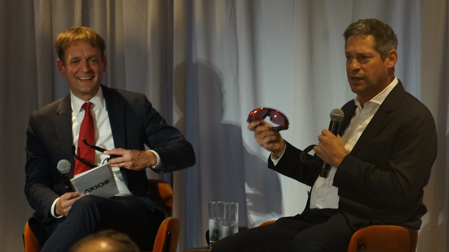 Joel Kaplan, right, speaking into a microphone on stage next to Axios publisher Nicholas Johnston