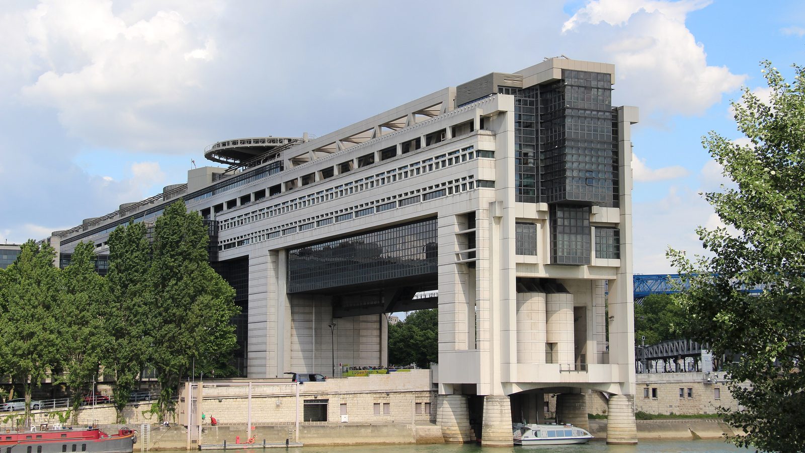 The large modern building of France's Ministry of Economy and Finance at Bercy, Paris, spanning a road beside the River Seine
