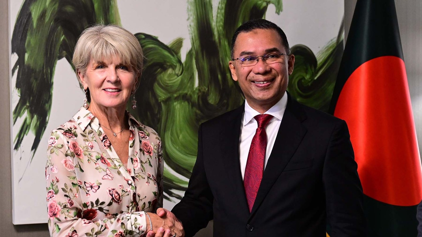 UN Special Envoy on Myanmar Julie Bishop shakes hands with Bangladesh Prime Minister Tarique Rahman in front of a green painting and a Bangladeshi flag