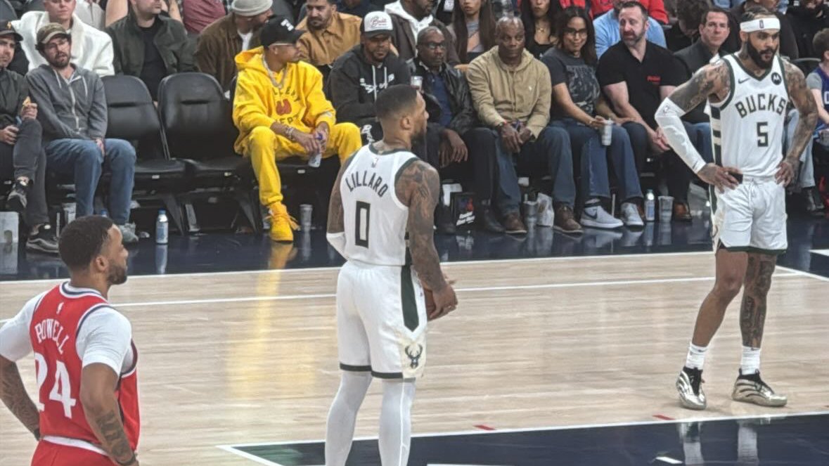 Damian Lillard in a white Milwaukee Bucks jersey on court during a game
