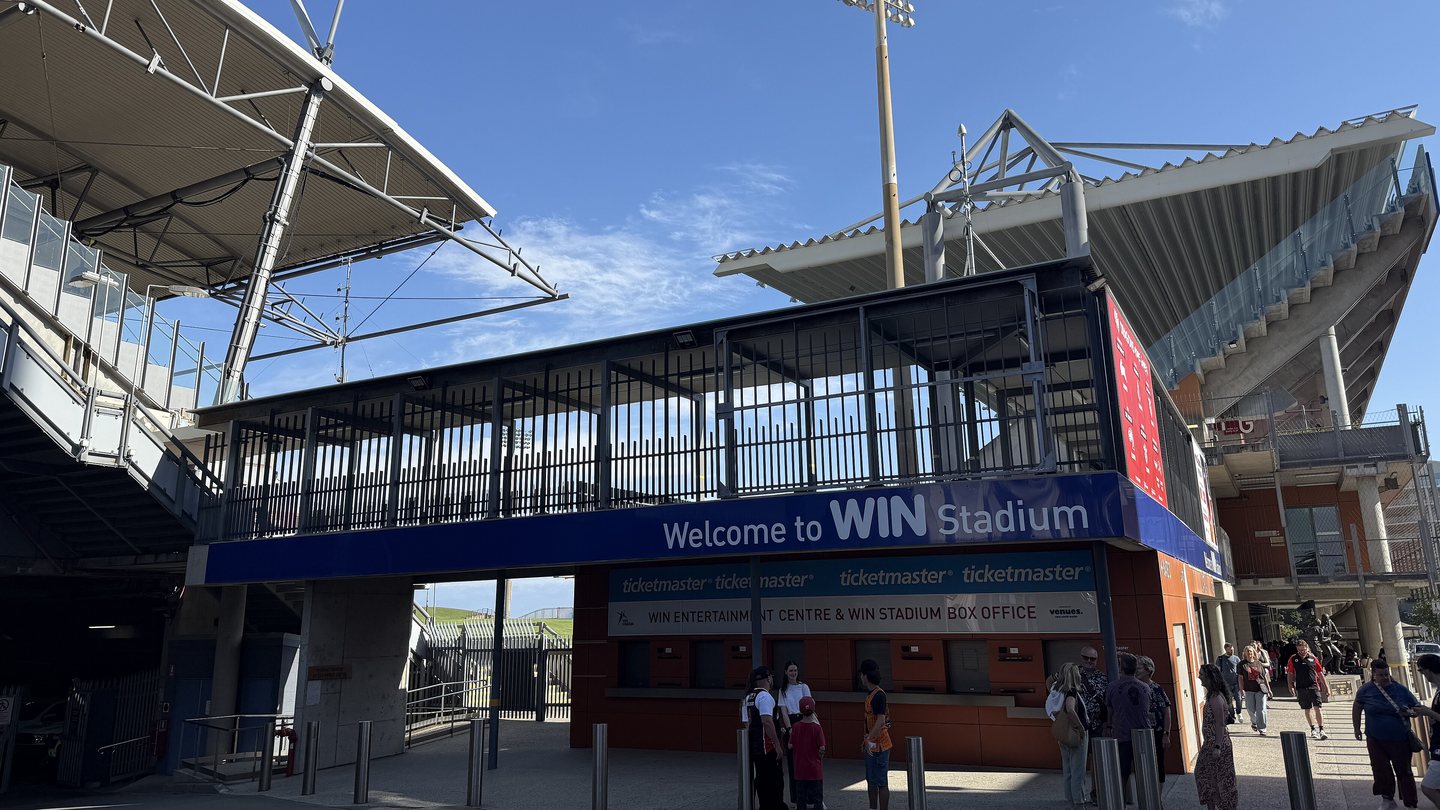 The entrance to WIN Stadium in Wollongong, with a blue 'Welcome to WIN Stadium' sign under the grandstand roof