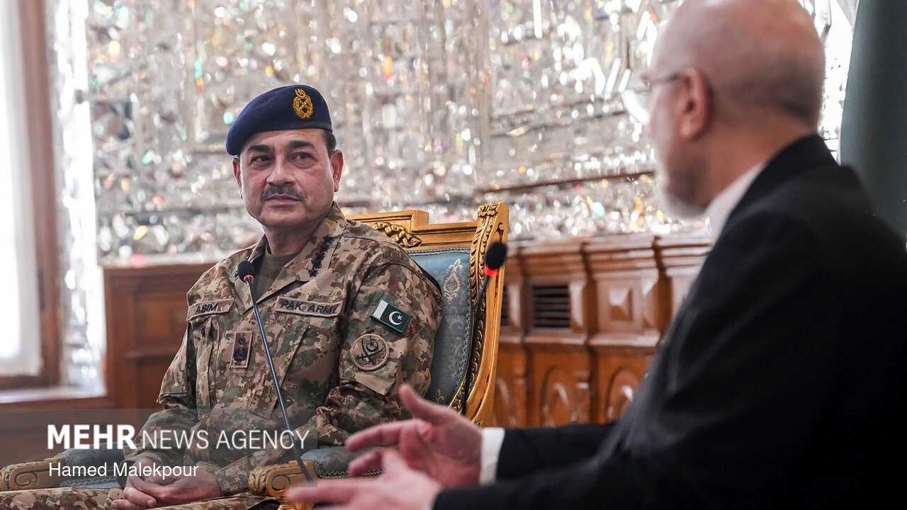 Pakistan's army chief Field Marshal Asim Munir, in camouflage uniform and a dark beret, seated in a meeting room in Tehran's parliament building