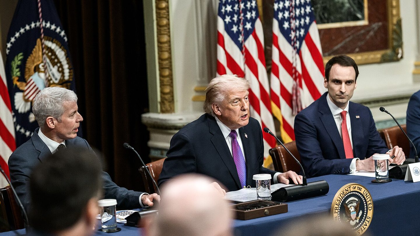 President Donald Trump seated at a long table with officials and executives during the Ratepayer Protection Pledge roundtable at the White House