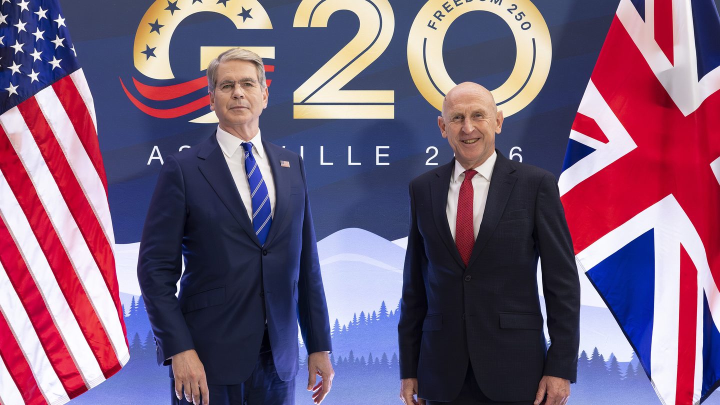 UK Chancellor John Healey, right, and US Treasury Secretary Scott Bessent stand in front of a G20 Asheville backdrop with US and UK flags