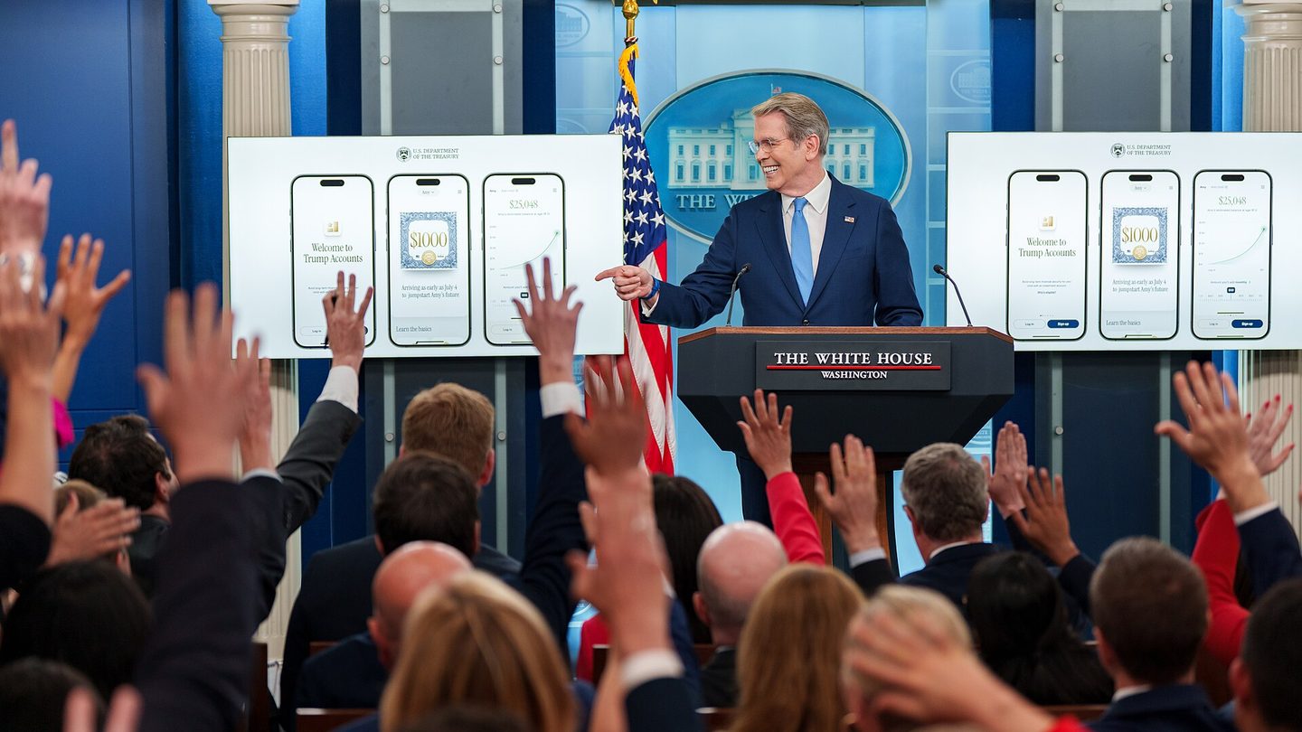 US Treasury Secretary Scott Bessent smiles and points from the podium of the White House briefing room as reporters raise their hands